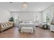 Serene main bedroom featuring hardwood floors, neutral decor, and natural light at 9419 Alturas Babson Park Cutoff Rd, Bartow, FL 33830