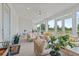 Inviting sunroom with comfortable seating, ceiling fan, and views of the surrounding landscape at 9419 Alturas Babson Park Cutoff Rd, Bartow, FL 33830