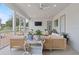 Cozy sunroom with wicker furniture, a ceiling fan, and views of the outdoors at 9419 Alturas Babson Park Cutoff Rd, Bartow, FL 33830