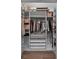 Walk-in closet featuring custom shelving, drawers, hanging rods and a dedicated shoe storage area at 9419 Alturas Babson Park Cutoff Rd, Bartow, FL 33830