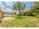 Large backyard with mature trees and a stone fire pit at 1856 Laredo Dr, Deltona, FL 32738