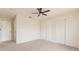 Neutral bedroom with ceiling fan, carpeted floor, and a pair of closets at 1856 Laredo Dr, Deltona, FL 32738