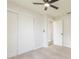 Cozy bedroom featuring a ceiling fan and double-door closet space at 1856 Laredo Dr, Deltona, FL 32738
