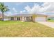 Charming brick home featuring an attached garage, well-maintained lawn, and a cozy, inviting appeal at 1856 Laredo Dr, Deltona, FL 32738