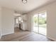 Modern kitchenette with stainless steel appliances, sleek white cabinetry, and a view of the outdoors at 1856 Laredo Dr, Deltona, FL 32738