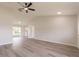 Bright living room featuring vaulted ceilings, a ceiling fan, and access to a kitchenette area at 1856 Laredo Dr, Deltona, FL 32738