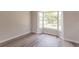 Bright room showcasing a bay window, fresh paint, and new flooring for a modern aesthetic at 1856 Laredo Dr, Deltona, FL 32738