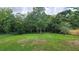 Expansive backyard features lush green grass and mature trees providing shade and privacy at 2506 Bonneville Dr, Orlando, FL 32826