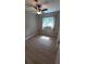 Bright, clean bedroom with laminate flooring, ceiling fan, and a sunny window at 2506 Bonneville Dr, Orlando, FL 32826