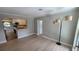 Open-concept living room with new flooring and neutral paint, flowing into an open kitchen at 2506 Bonneville Dr, Orlando, FL 32826