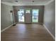 Bright living room featuring new flooring, fresh paint, and a door with large windows at 2506 Bonneville Dr, Orlando, FL 32826