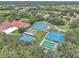 Aerial view of the community tennis and bocce ball courts surrounded by lush landscaping at 5402 Rosewall Cir, Leesburg, FL 34748