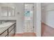 Bathroom featuring dual mirrors over the vanity and an entrance to a walk-in closet at 5402 Rosewall Cir, Leesburg, FL 34748