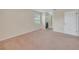Bedroom featuring neutral carpet and a view of the en-suite bathroom at 5402 Rosewall Cir, Leesburg, FL 34748