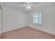 Simple bedroom featuring a ceiling fan, carpet flooring and one window at 5402 Rosewall Cir, Leesburg, FL 34748