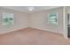 Bedroom featuring neutral carpet, two windows, and a ceiling fan at 5402 Rosewall Cir, Leesburg, FL 34748