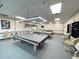 Spacious billiard room features multiple pool tables, lighting, seating, and entertainment amenities at 5402 Rosewall Cir, Leesburg, FL 34748