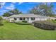 Charming single-story home featuring a well-manicured lawn and mature landscaping at 5402 Rosewall Cir, Leesburg, FL 34748