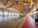 Expansive gymnasium or activity space with high ceilings, natural light, and a versatile layout at 5402 Rosewall Cir, Leesburg, FL 34748