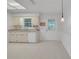Bright kitchen featuring sleek white appliances, and views of the door to the backyard at 5402 Rosewall Cir, Leesburg, FL 34748