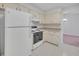 Functional kitchen with classic white appliances and cabinets, offers a comfortable cooking space at 5402 Rosewall Cir, Leesburg, FL 34748