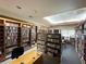 Community library with rows of bookshelves and a cozy reading area at 5402 Rosewall Cir, Leesburg, FL 34748