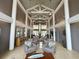 Elegant lobby area with high ceilings, comfortable seating, stylish decor, and a welcoming atmosphere at 5402 Rosewall Cir, Leesburg, FL 34748