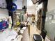 Functional storage room with shelving, workbench, and visible utilities at 5402 Rosewall Cir, Leesburg, FL 34748