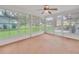 Spacious sunroom with views of the expansive backyard and lush greenery at 5402 Rosewall Cir, Leesburg, FL 34748
