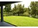 Green backyard featuring a well-manicured lawn and a view of the water, enhanced by a secure wrought iron fence at 1319 Heavenly Cv, Winter Park, FL 32792