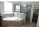 Luxurious Primary bathroom with a soaking tub, tiled shower, and custom closet at 1319 Heavenly Cv, Winter Park, FL 32792