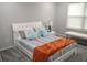 Bright bedroom featuring a large window, striped bedding, and modern decor at 1319 Heavenly Cv, Winter Park, FL 32792