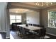 Elegant dining room with a modern chandelier, tray ceiling, and a large table with seating for twelve at 1319 Heavenly Cv, Winter Park, FL 32792