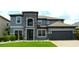 Beautiful two-story home with a stone-accented entrance and well-manicured lawn at 1319 Heavenly Cv, Winter Park, FL 32792