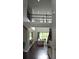 Bright foyer with hardwood floors, wrought iron railing, and soaring ceilings overlooking the living room at 1319 Heavenly Cv, Winter Park, FL 32792