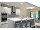 Modern kitchen with sleek white cabinets, stainless steel appliances and waterfall island with seating at 1319 Heavenly Cv, Winter Park, FL 32792