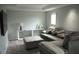 Cozy living room with plush sectional, soft carpet, and modern decor at 1319 Heavenly Cv, Winter Park, FL 32792