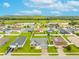 Community aerial view showcasing homes with well-manicured lawns and a view of a lake in the background at 2053 Charleston Ln, Bartow, FL 33830