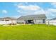 Large backyard with fire pit, outdoor seating, and ample space for activities at 2053 Charleston Ln, Bartow, FL 33830