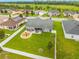 Aerial view of a spacious backyard with a white fence, patio furniture, and a play area at 2053 Charleston Ln, Bartow, FL 33830