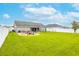 Expansive backyard featuring a well-maintained lawn and a cozy fire pit area at 2053 Charleston Ln, Bartow, FL 33830