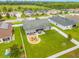 Aerial view of backyard with fire pit, patio seating, fenced yard, and well-maintained lawn at 2053 Charleston Ln, Bartow, FL 33830