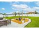 Spacious backyard with a custom fire pit area, perfect for outdoor entertaining at 2053 Charleston Ln, Bartow, FL 33830
