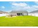 Wide backyard showcasing a stylish fire pit area and plenty of green space at 2053 Charleston Ln, Bartow, FL 33830
