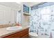 Well-lit bathroom featuring a vanity with stone countertops and a themed shower curtain at 2053 Charleston Ln, Bartow, FL 33830
