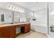 Elegant bathroom boasts double sinks, granite counters, a soaking tub, and walk-in shower at 2053 Charleston Ln, Bartow, FL 33830