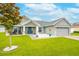 Beautiful home with manicured lawn, covered porch, and a two-car garage at 2053 Charleston Ln, Bartow, FL 33830