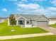 Attractive home with a well-manicured lawn, cozy porch, and a spacious two-car garage at 2053 Charleston Ln, Bartow, FL 33830