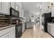 Modern kitchen boasts gray cabinets, granite countertops, and stainless steel appliances at 2053 Charleston Ln, Bartow, FL 33830