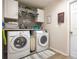 Functional laundry room with washer, dryer, folding space, and storage cabinets at 2053 Charleston Ln, Bartow, FL 33830
